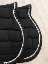 Two Anna Scarpati saddle pads black with white trim